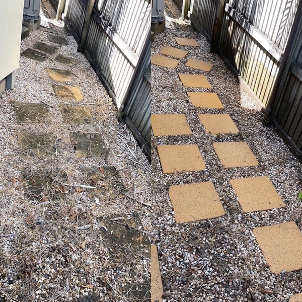 A paved side path with gravel edging and weathered concrete pavers